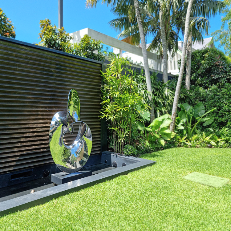 stainless steel water sculpture in garden