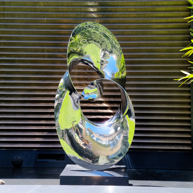 stainless steel water sculpture in garden