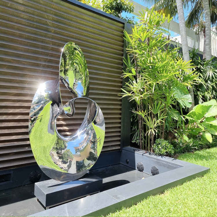 stainless steel water sculpture in garden