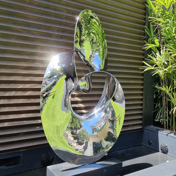 stainless steel water sculpture in garden